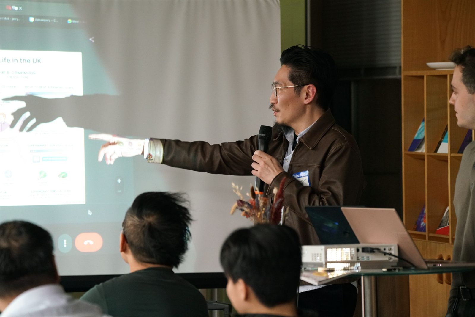 A participant presenting a "Life in the UK" AI companion prototype