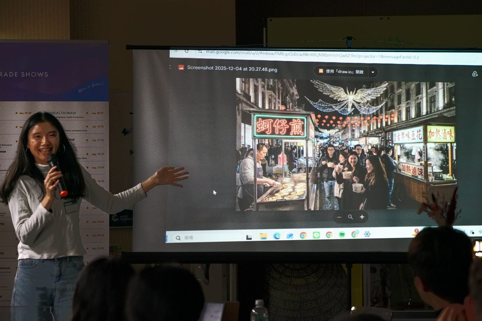 A presenter showing a cultural-storytelling concept blending Oxford Street and Taiwan street food