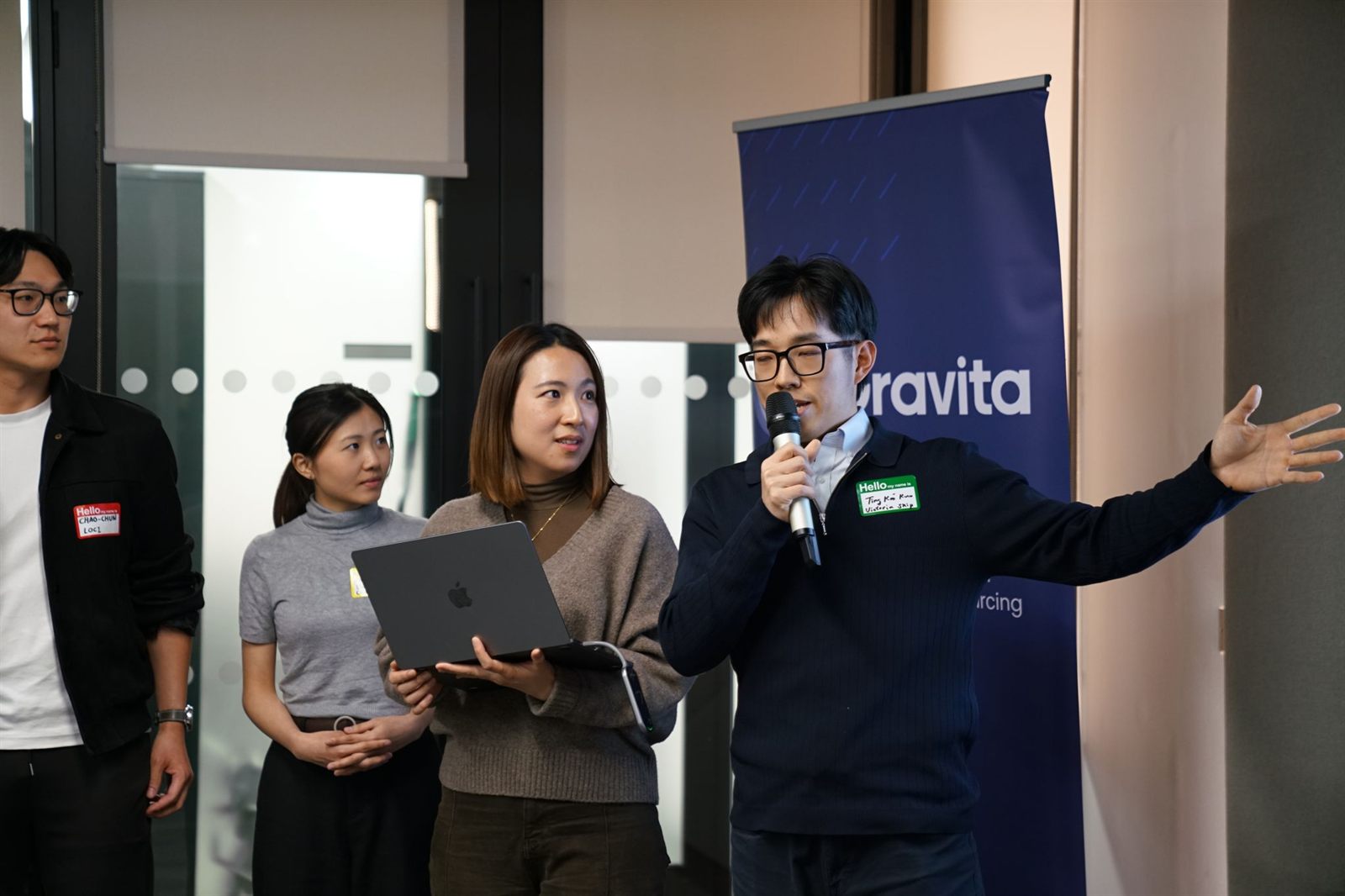 A team presenting their prototype beside the Gravita banner