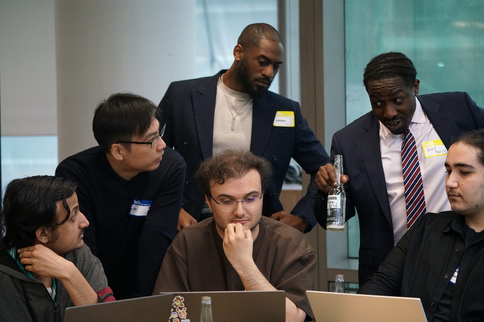 A team gathered around laptops during the build