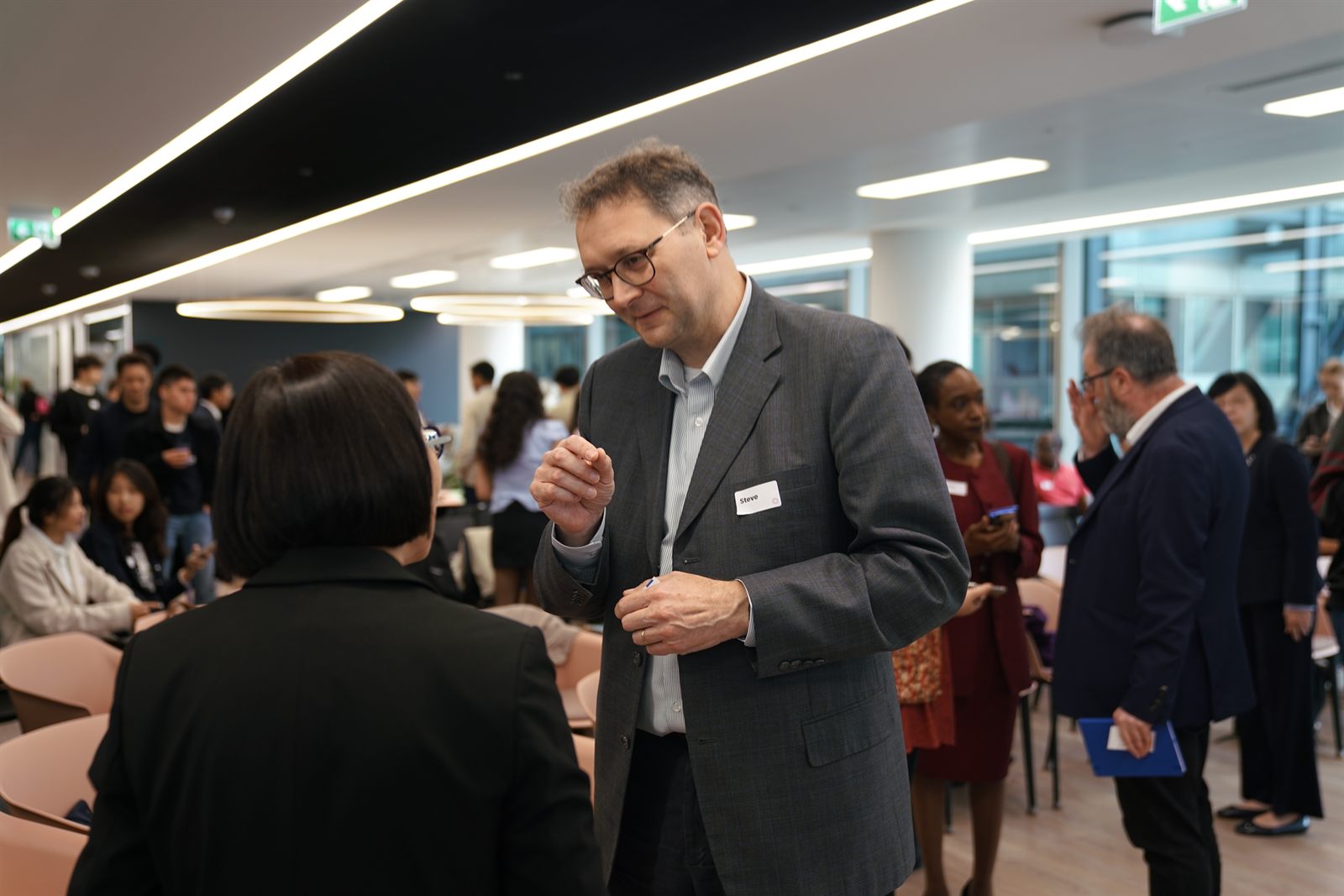 Attendees networking during the morning coffee break
