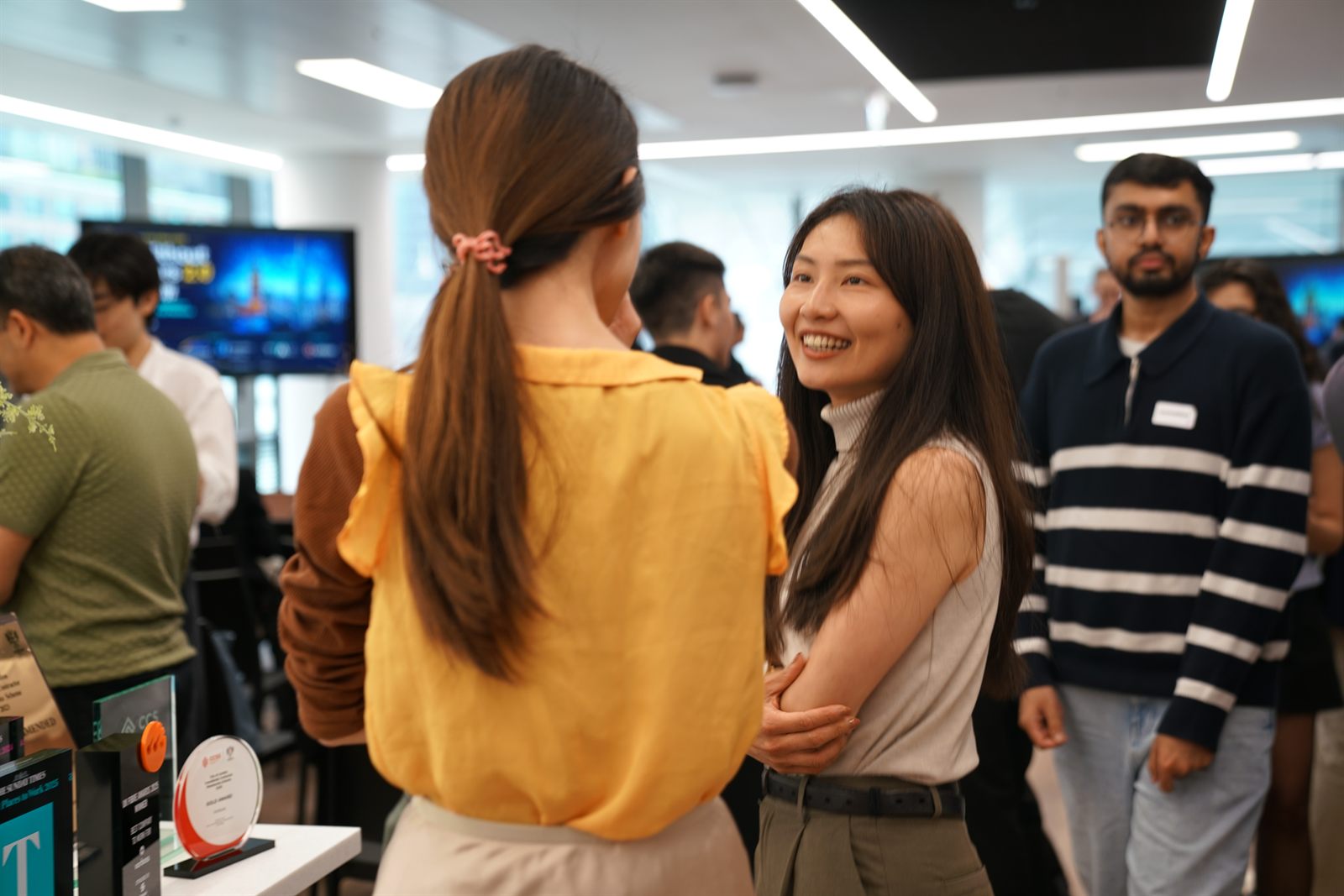 Attendees networking beside the startup display during the break