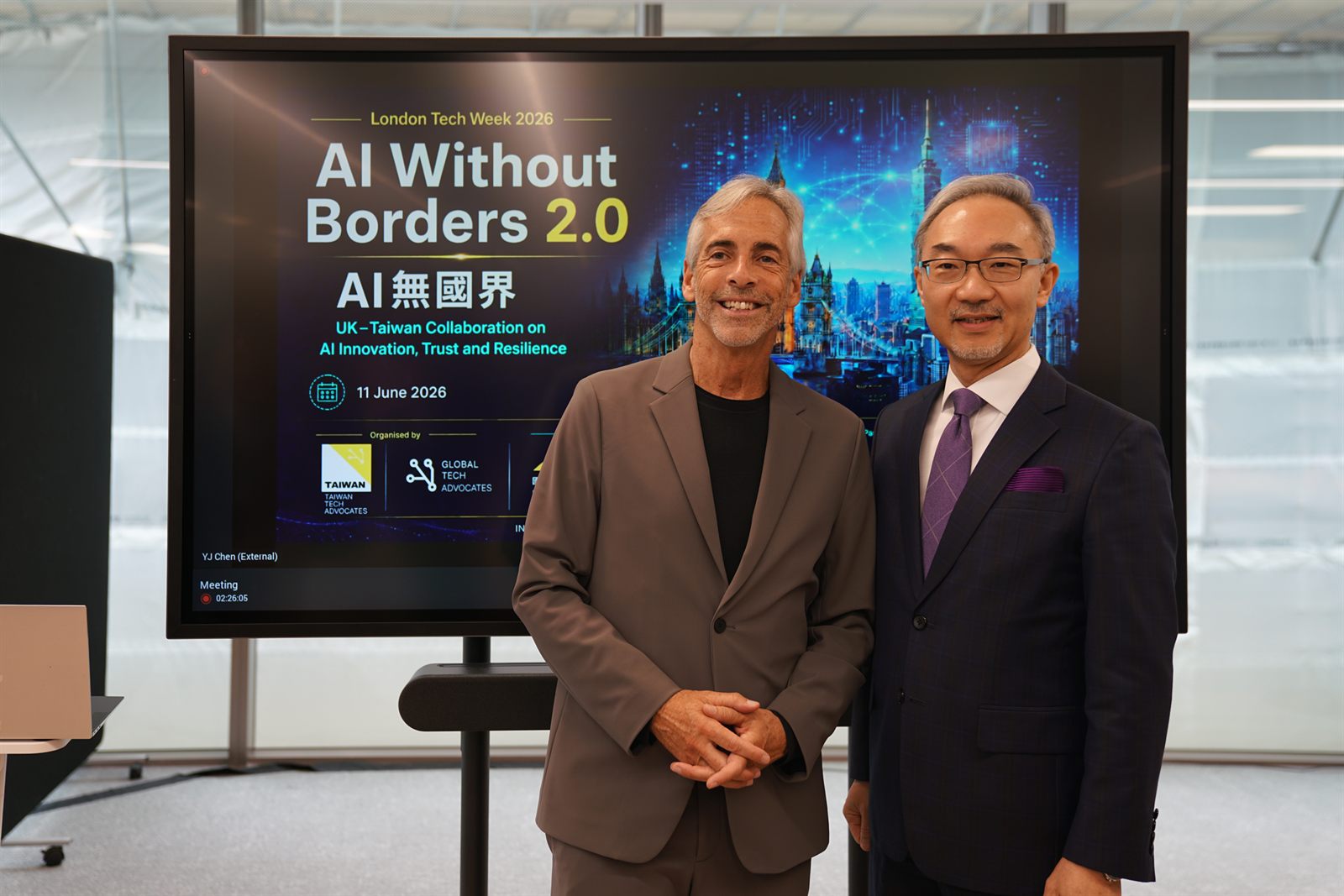 Russ Shaw CBE and Ambassador Vincent Yao in front of the AI Without Borders 2.0 screen