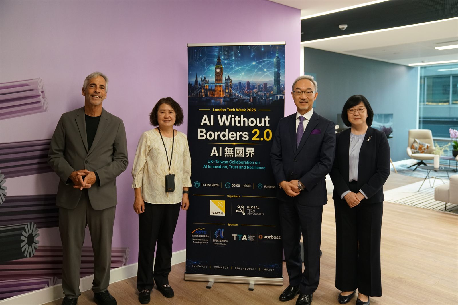 Russ Shaw CBE and Ambassador Vincent Yao with guests beside the event banner